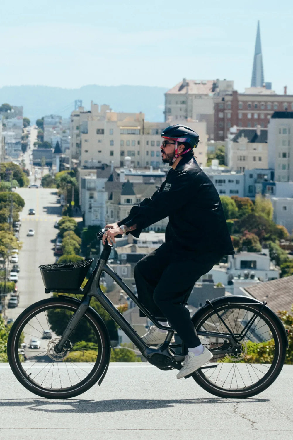 Rider on a city bike above San Francisco wearing Lumos Aero GT in Smoke